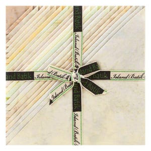May include: A stack of fabric squares in various pastel colors, tied with a black and green ribbon. The ribbon is printed with the words "Island Batik". The fabric is arranged in a diagonal pattern.
