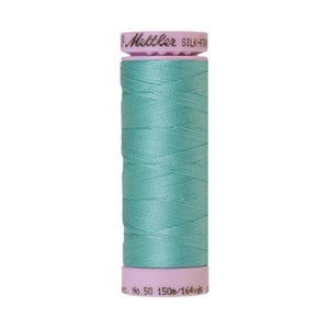 May include: A spool of light blue Gutermann Silk-Finish thread with a pink label that reads "Gutermann Silk-Finish" and "No. 50 150m/164 yds".