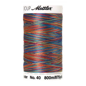 May include: A spool of multicolored thread with a white label that reads "Mettler Group No. 40 800m/875yds".