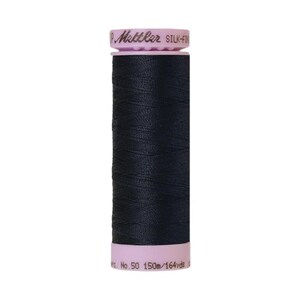 May include: A spool of black thread with a pink label that reads "Metzler Silk-Finish No. 50 150m/164 yds."