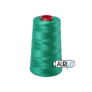 May include: A spool of bright green thread with a red core. The thread is tightly wound, creating a conical shape. The brand name "AURIfil" is printed on a white label on the side of the spool.