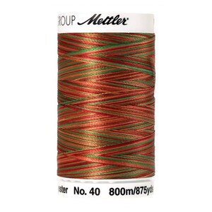 May include: A spool of Mettler Group thread in a red, orange, and green color combination. The spool is labeled "No. 40 800m/875 yds".