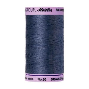 May include: A spool of dark blue thread labeled "Mettler Silk-Fine No.50 500m/547yds".