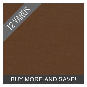 May include: A solid brown fabric with the text "12 YARDS" in white on a gray banner in the upper left corner. The text "BUY MORE AND SAVE!" is in white on a gray banner at the bottom.