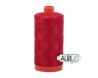 May include: A spool of red thread with an orange top and base. The thread is tightly wound, and the spool has the Aurifil logo on the side. This thread is likely used for sewing, quilting, or embroidery projects.
