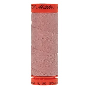 May include: A spool of pink thread with the text "Mettler" and "No. 100" on the label.