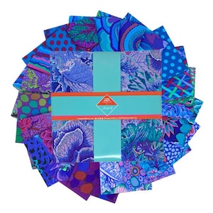 May include: A pack of 12 fat quarter fabric squares featuring a variety of colorful floral and geometric patterns in shades of blue, purple, green, and red. The fabric squares are arranged in a circle around a white card with the text "KATE HACKETT DESIGNS" printed in red.