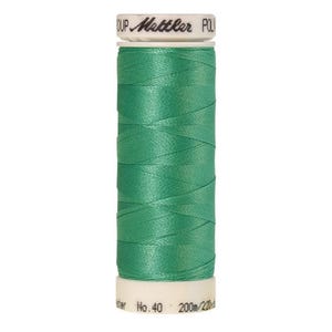 May include: A spool of green thread with a white label that reads "Mettler Poly Group No. 40 200m/220yd"