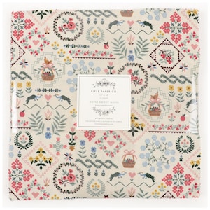 May include: A stack of fabric squares featuring a cream background with a repeating pattern of flowers, birds, hearts, and baskets. A central label reads: RIFLE PAPER CO. 10" x 10" 42 PIECES HOME SWEET HOME Screen Printed in Japan RP100P-10X10.