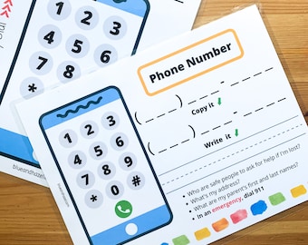 May include: Educational cards with a blue smartphone graphic and number keypad. The cards include fill-in-the-blank sections for phone numbers, address, and emergency contacts. The text on the card says "In an emergency, dial 911".