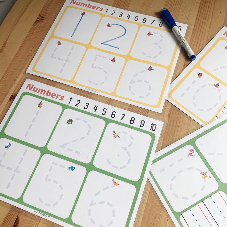 May include: Two printable worksheets for learning to write numbers. The first worksheet has a yellow background and features butterflies. The second worksheet has a green background and features dinosaurs. Both worksheets have dotted lines to help trace the numbers.