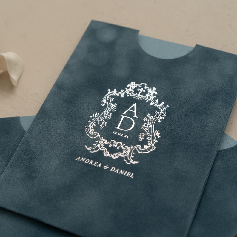 A close-up of a dark blue fabric with a white monogram design and text printed on it.