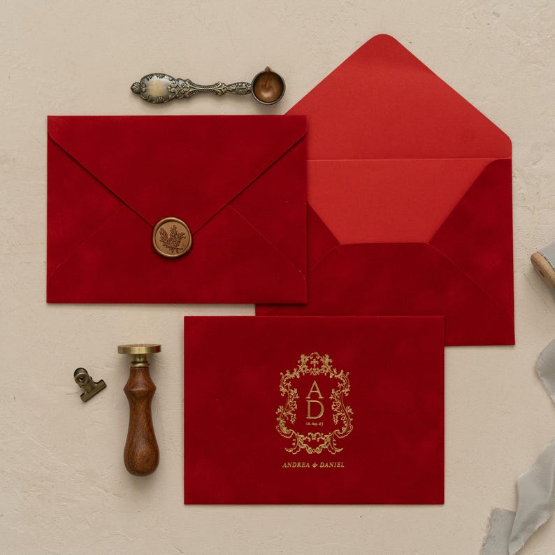 a red envelope with a gold seal, a wooden vice, and a gold stamp, all arranged on a white surface.