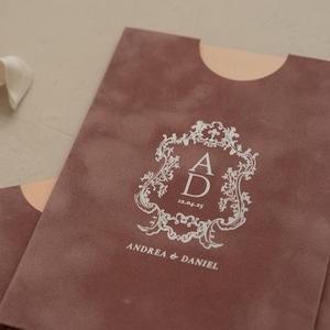 A close-up of a brown fabric with a white decorative emblem and text on it.