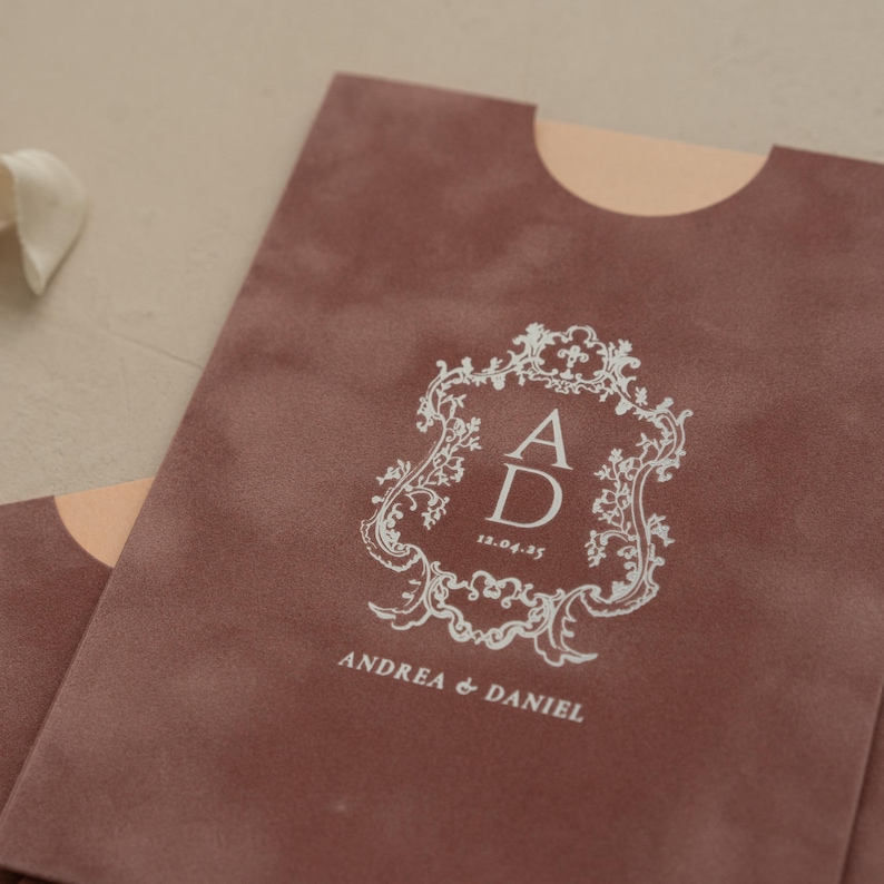 A close-up of a brown fabric with a white decorative emblem and text on it.