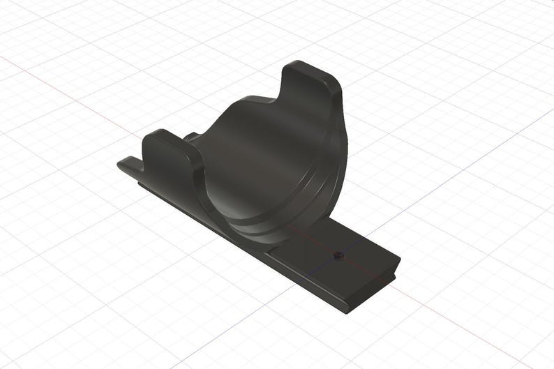 May include: A matte black, U-shaped mounting bracket featuring a curved cradle for cylindrical objects and a flat, rectangular base plate with a single centred screw hole for secure attachment to a flat surface.