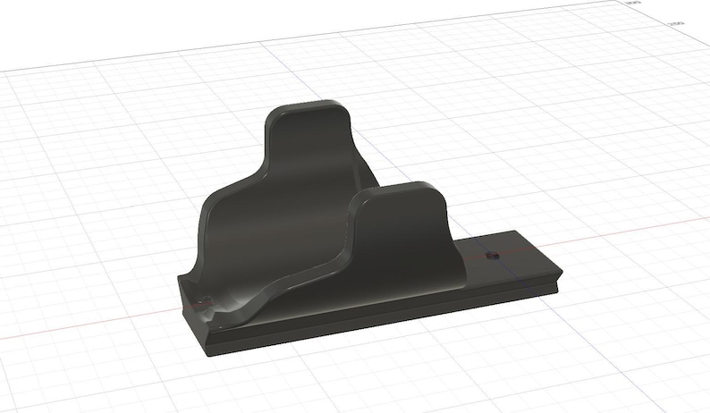 May include: A black, stylized bracket with a curved design. The bracket has a rectangular base with a decorative edge and a vertical support with a curved top. The design is rendered in a 3D style.
