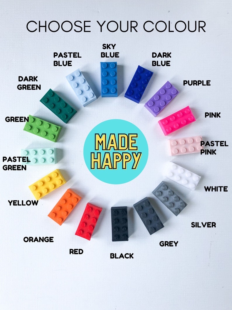 May include: An image with the text "CHOOSE YOUR COLOUR" and "MADE HAPPY". It displays various colorful toy building blocks in shades of green, blue, purple, pink, yellow, orange, red, black, grey, white, and silver. Each block is labeled with its color.
