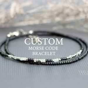 May include: A delicate black and silver beaded bracelet with the text "CUSTOM MORSE CODE BRACELET" on a gray background.