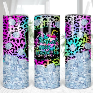 May include: A stainless steel tumbler with a pink, blue, and green leopard print design. The tumbler has a clear lid and is filled with ice. The text "Mama Needs a Loaded Tea" is printed on the tumbler.