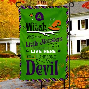 May include: A green Halloween garden flag with a witch's hat and the text "A Witch and her Little Monsters Live Here with a Handsome Devil".