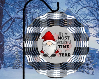 May include: A decorative Christmas ornament featuring a gnome in a red hat and the text "It's the MOST Wonderful TIME of the YEAR." The ornament has a black and white plaid pattern and is hanging from a black hook.