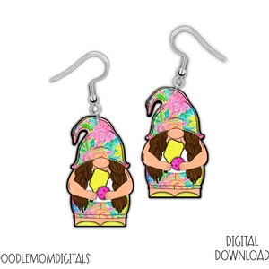 May include: A pair of earrings featuring a gnome holding a yellow popsicle and a purple ball. The gnome is wearing a floral patterned hat and a yellow and pink patterned dress. The earrings are silver.