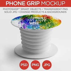 May include: A white phone grip mockup with a colorful abstract design. The grip has a collapsible, accordion-style body and a round base. Text on the grip reads "YOUR ART WORK HERE". The image also includes text that reads "PHONE GRIP MOCKUP".