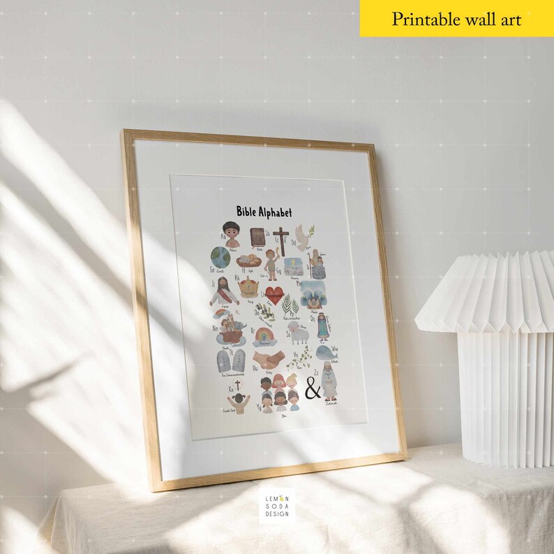 May include: Framed print featuring a colorful Bible Alphabet illustration. The artwork includes various religious symbols and characters, with the title "Bible Alphabet" at the top. The print is in a light wood frame, suitable for children's rooms or religious education.