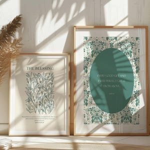 May include: Two framed prints with a white background and green floral designs. The print on the left features a botanical illustration of a plant with the text "The Blessing" and a Bible verse. The print on the right features a green circle with the text "Every good gift and every perfect gift is from above" and a Bible verse.