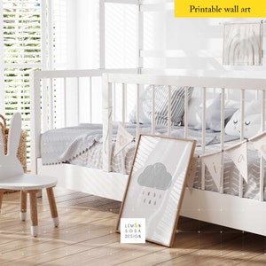May include: White wooden bunk bed with a gray and white striped blanket, a gray cloud with raindrops print, and a white bunny chair. The bed has a white railing and a white headboard. The room has a white wall and a window with white blinds.