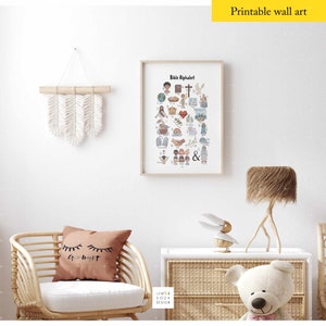 May include: A framed "Bible Alphabet" print with colorful illustrations, displayed on a white wall. The room features a woven chair, a decorative wall hanging, and a teddy bear. The text "Printable wall art" is visible.