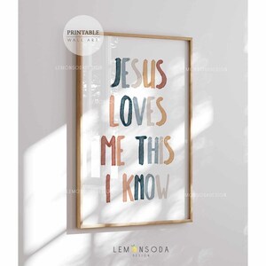 May include: A printable wall art print with the text "Jesus Loves Me This I Know" in colorful, stylized lettering. The background is white with a subtle texture.