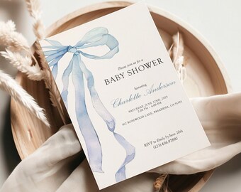 May include: Baby shower invitation with a watercolor blue ribbon design. The invitation includes the text "BABY SHOWER" and details for the event, including the honoree's name, date, time, and location. RSVP information is also provided.