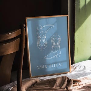 May include: A blue poster with a white outline of two cowboy boots. The text "Walk in Love" is printed below the boots.