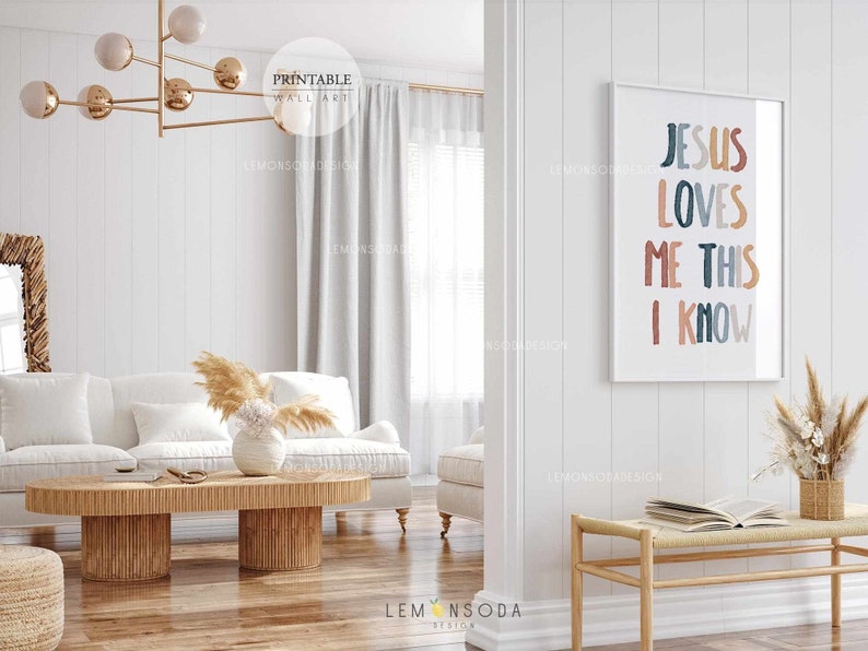 May include: A white couch with a wooden coffee table in front of it. The wall behind the couch has a framed print with the text "Jesus Loves Me This I Know" in colorful letters.