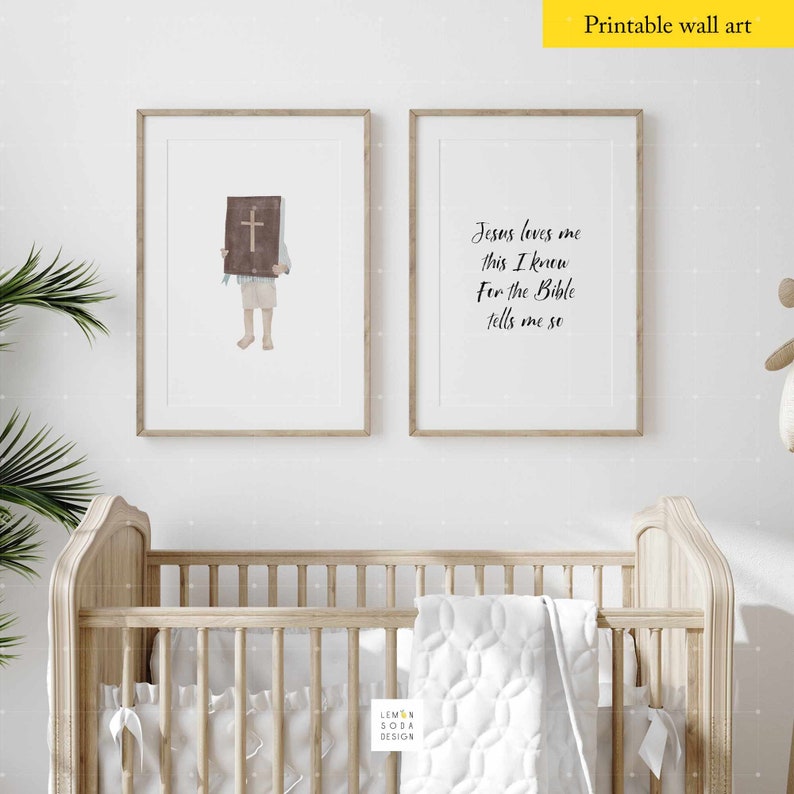 May include: Two framed prints with a white background and black text. The print on the left shows a child holding a book with a cross on the cover. The print on the right says "Jesus loves me this I know For the Bible tells me so".