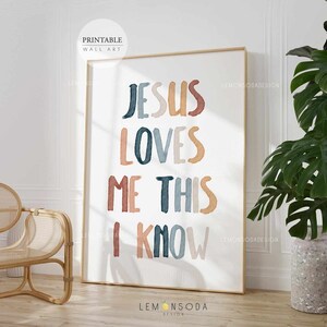 May include: A printable wall art print with the text "Jesus Loves Me This I Know" in colorful, stylized lettering. The text is in a watercolor style with shades of blue, orange, and pink.