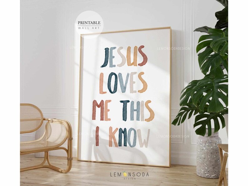 May include: A printable wall art print with the text "Jesus Loves Me This I Know" in colorful, stylized lettering. The text is in a watercolor style with shades of blue, orange, and pink.
