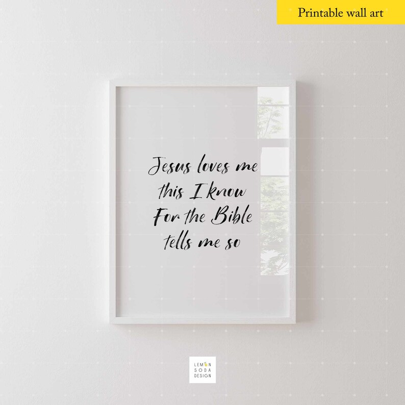 May include: A white framed printable wall art with the text "Jesus loves me this I know For the Bible tells me so" in black cursive font.