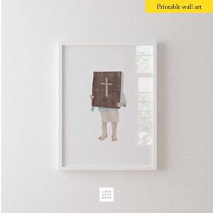 May include: A watercolor illustration of a child holding a brown book with a cross on the cover. The child is wearing a blue and white shirt and beige shorts. The illustration is framed in a white frame.