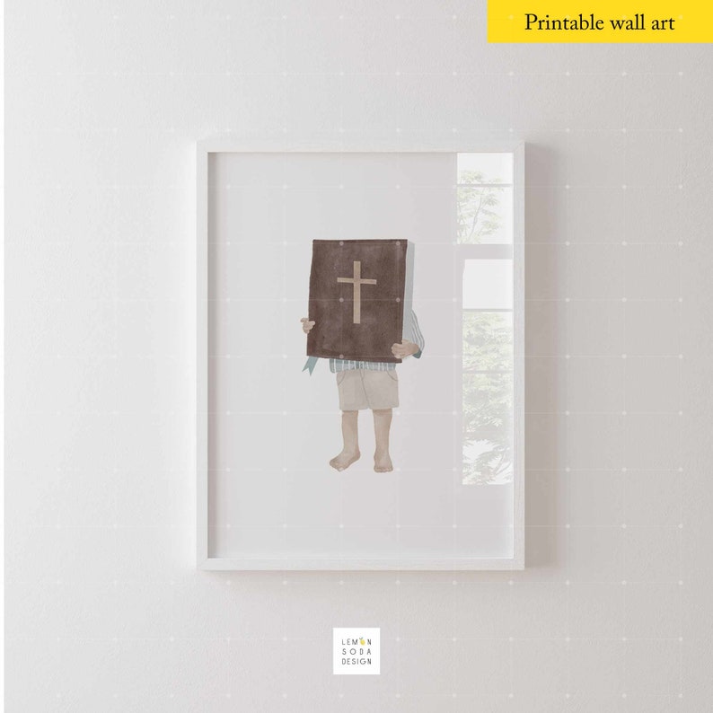 May include: A watercolor illustration of a child holding a brown book with a cross on the cover. The child is wearing a blue and white shirt and beige shorts. The illustration is framed in a white frame.