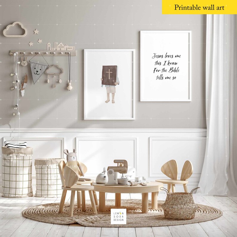 May include: A set of two printable wall art prints with a Christian theme. The first print features a child holding a Bible with a cross on the cover. The second print features the text "Jesus loves me this I knew For the Bible tells me so".