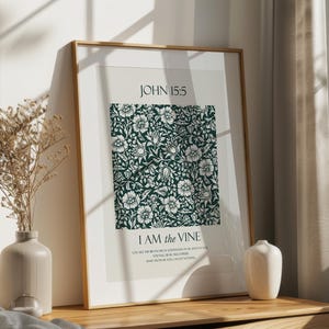 May include: A framed print with a green floral pattern and the text "JOHN 15:5 I AM the VINE" in white. The print is on a white background and has a wooden frame.