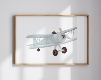May include: A framed print of a watercolor illustration of a light blue airplane with brown wheels and a propeller. The airplane is flying in the sky.