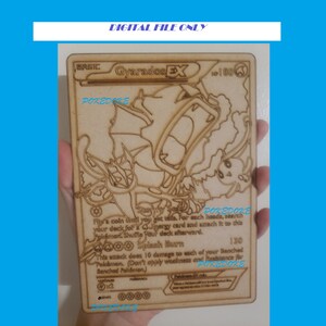 May include: A wooden Pokemon card featuring Gyarados EX, a water-type Pokemon. The card is brown and has a white outline. The card has the text "Gyarados EX" and "POKEDOKE" on it.