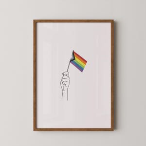 May include: A black and white line drawing of a hand holding a rainbow pride flag with a black triangle in the top left corner.