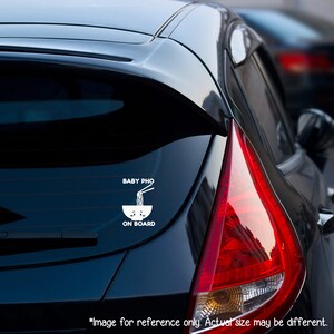 May include: A white vinyl car sticker with the text "BABY PHO ON BOARD" and a cartoon image of a bowl of noodles with chopsticks.