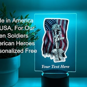 May include: A personalized LED night light with a design of a soldier standing in front of an American flag. The text "Your Text Here" is displayed below the image.