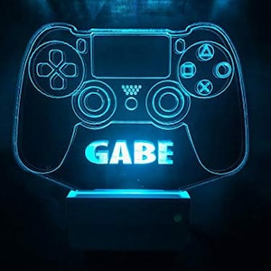 May include: A blue illuminated 3D printed PlayStation controller night light with the name "GAEB" printed on the front.